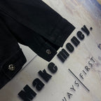 Black denim jacket cuff detail with snap buttons on sleeve and side seam