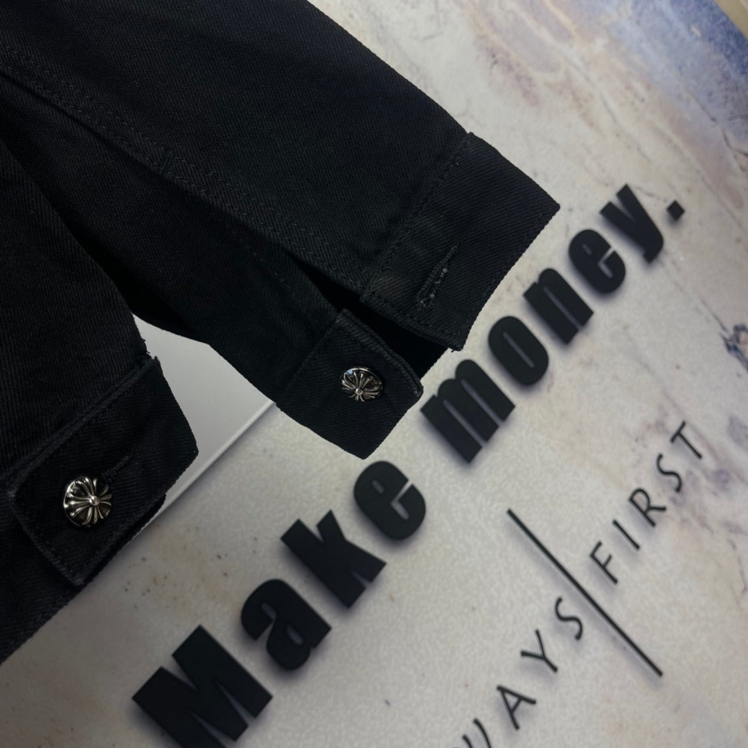 Black denim jacket cuff detail with snap buttons on sleeve and side seam