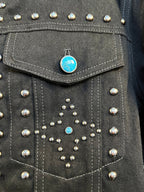 Dark denim jacket chest panel with silver studs and blue rhinestone accents.