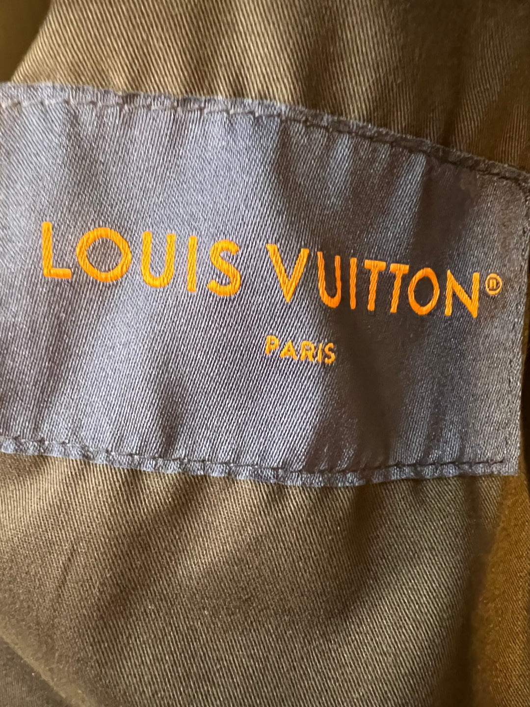 Louis Vuitton fabric label on inner side seam, with “Paris” text.