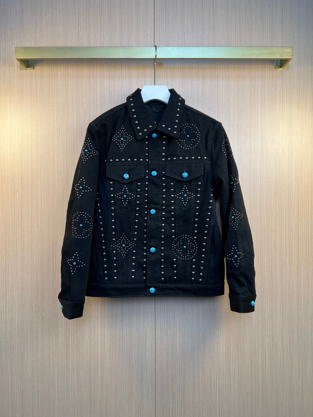 Dark denim jacket with studded embellishments and button front, long sleeves.
