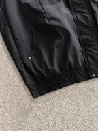 Dior long black jacket lower hem with gathered elastic and snap front details