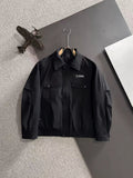 Dior long black jacket with stand collar, snap flap pockets, and full sleeves