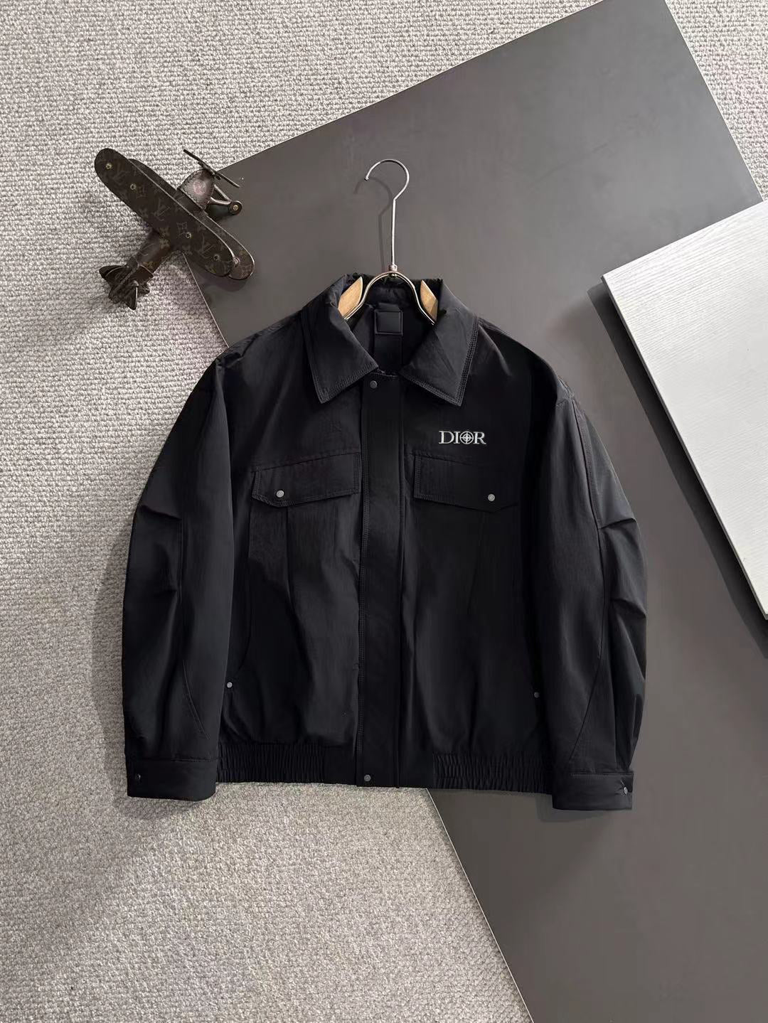 Dior long black jacket with stand collar, snap flap pockets, and full sleeves