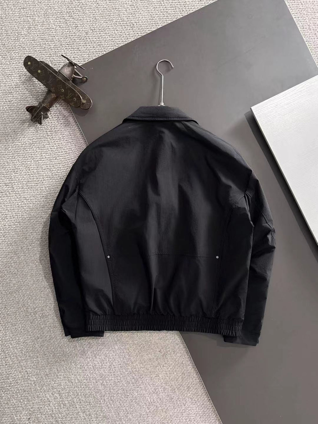 Dior long black jacket back view with button details and elastic hem