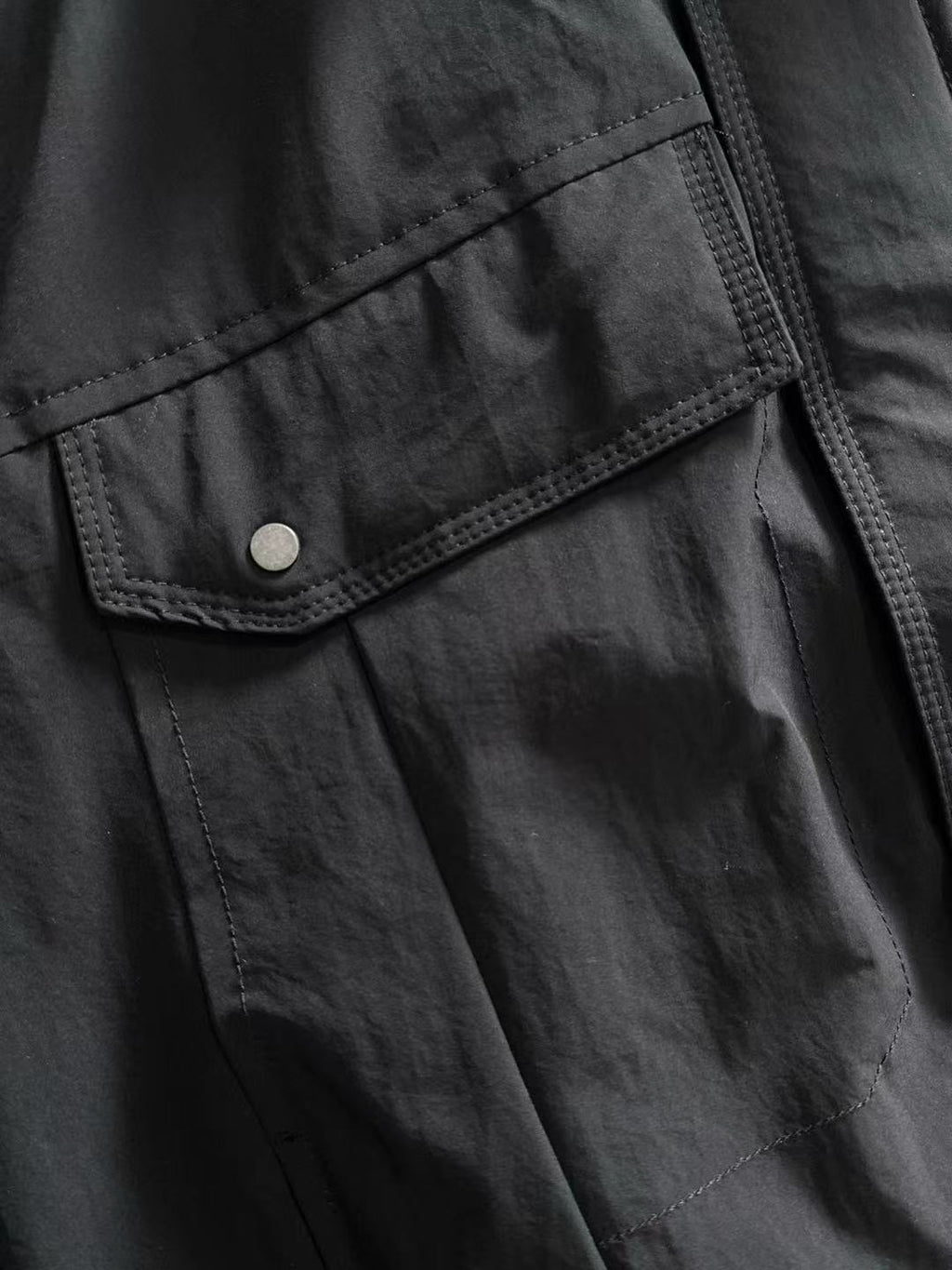 Dior long black jacket front with snap button flap pocket and stitched panel seams