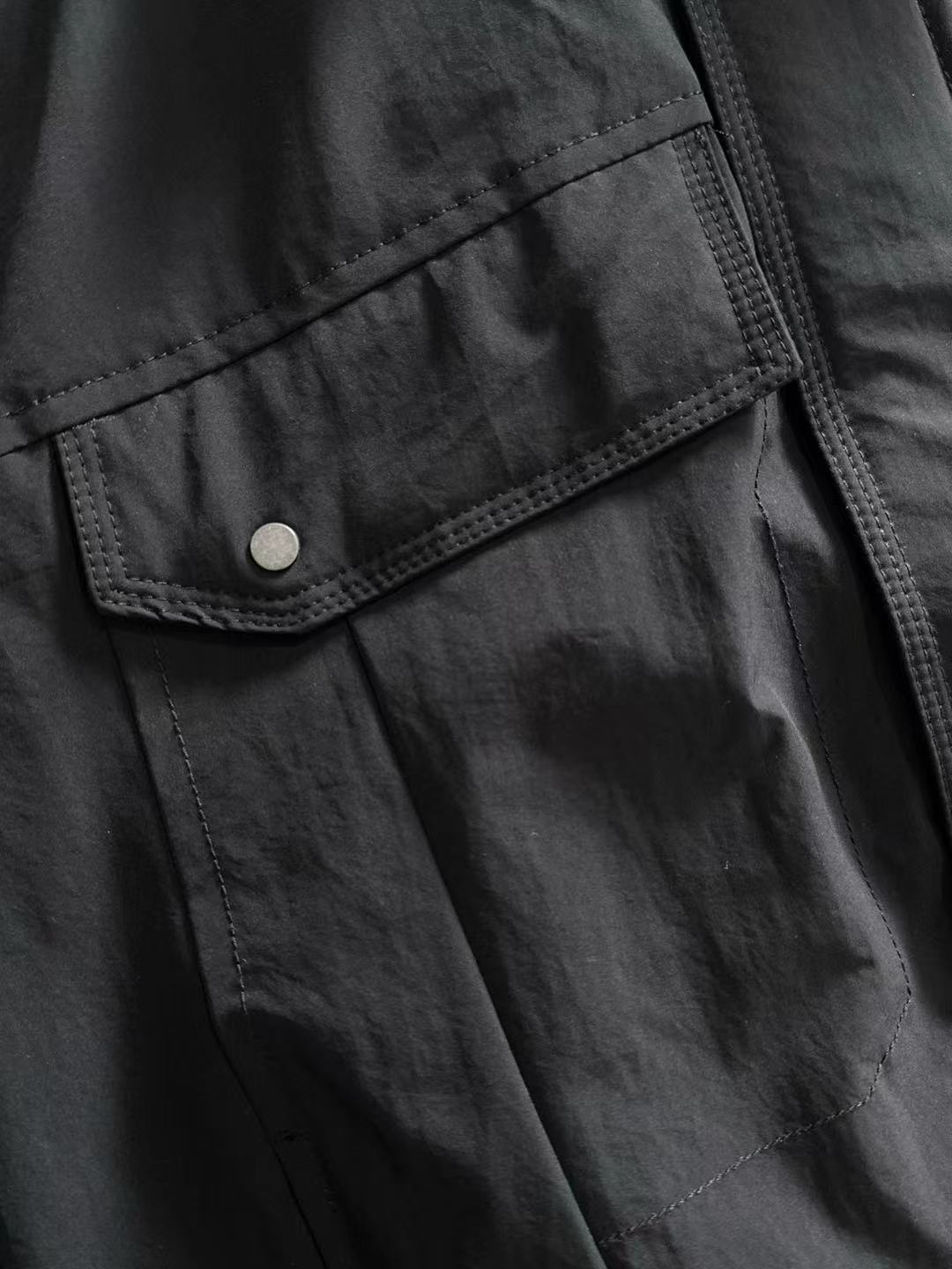 Dior long black jacket front with snap button flap pocket and stitched panel seams