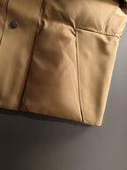 Moncler long puffer jacket lower front with dark buttons and side seam