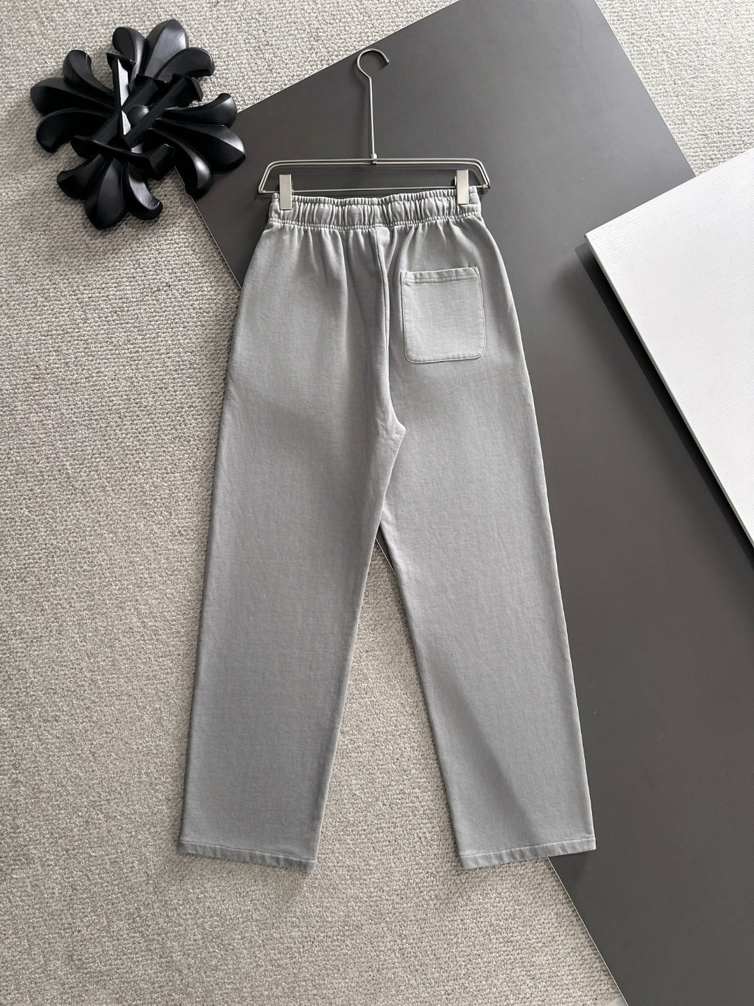 Stone Island light gray sweatpants with logo patch, elastic waist, and straight leg fit