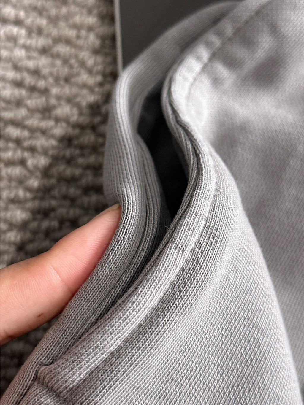 Stone Island light gray knit fabric close-up with ribbed seam and texture