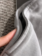 Stone Island light gray knit fabric close-up with ribbed seam and texture