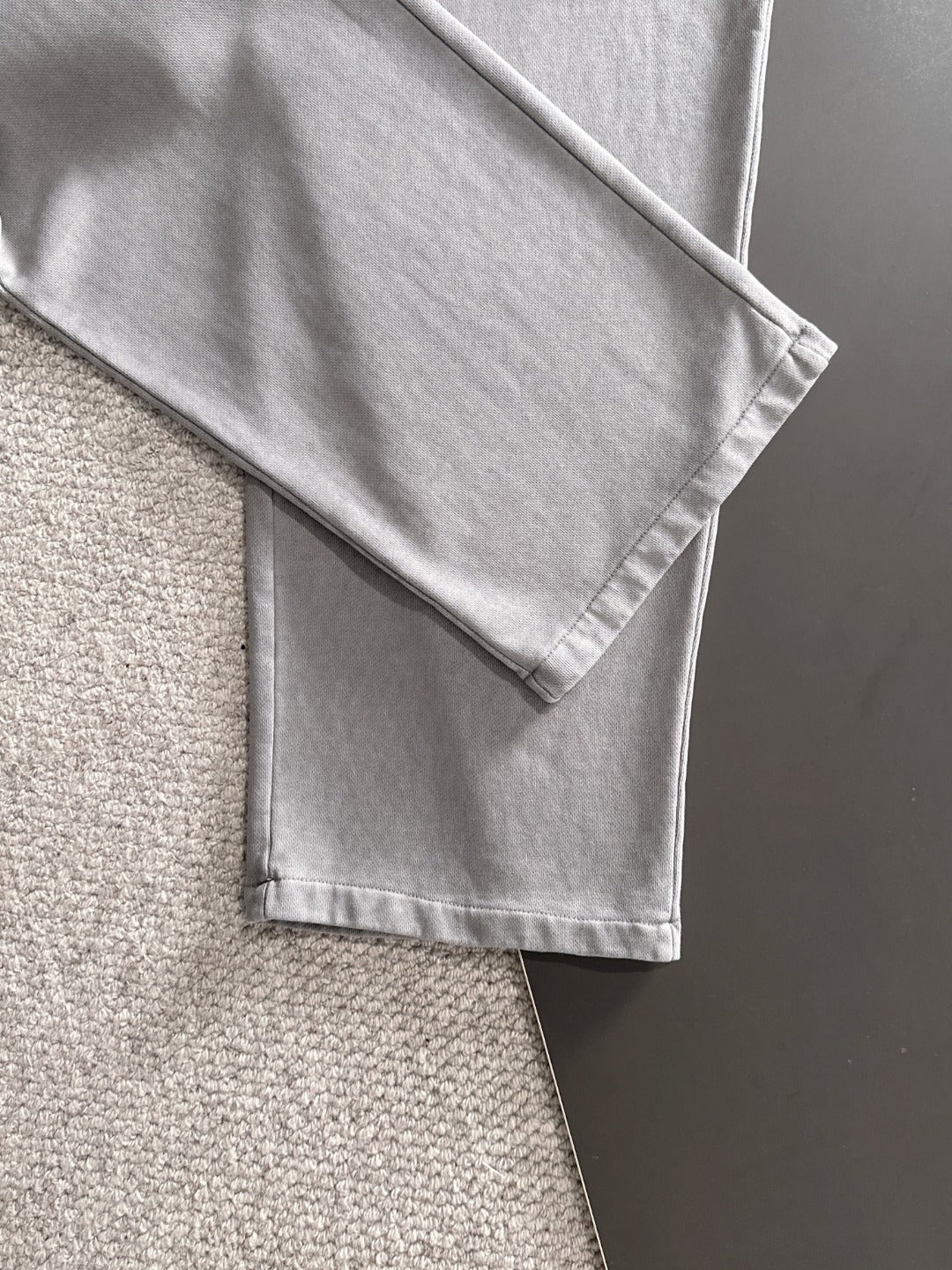 Stone Island light gray sweatpants with folded hem and visible side seam