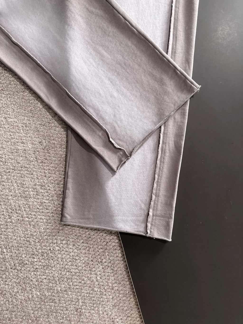 Light gray pants cuff and side seam close-up