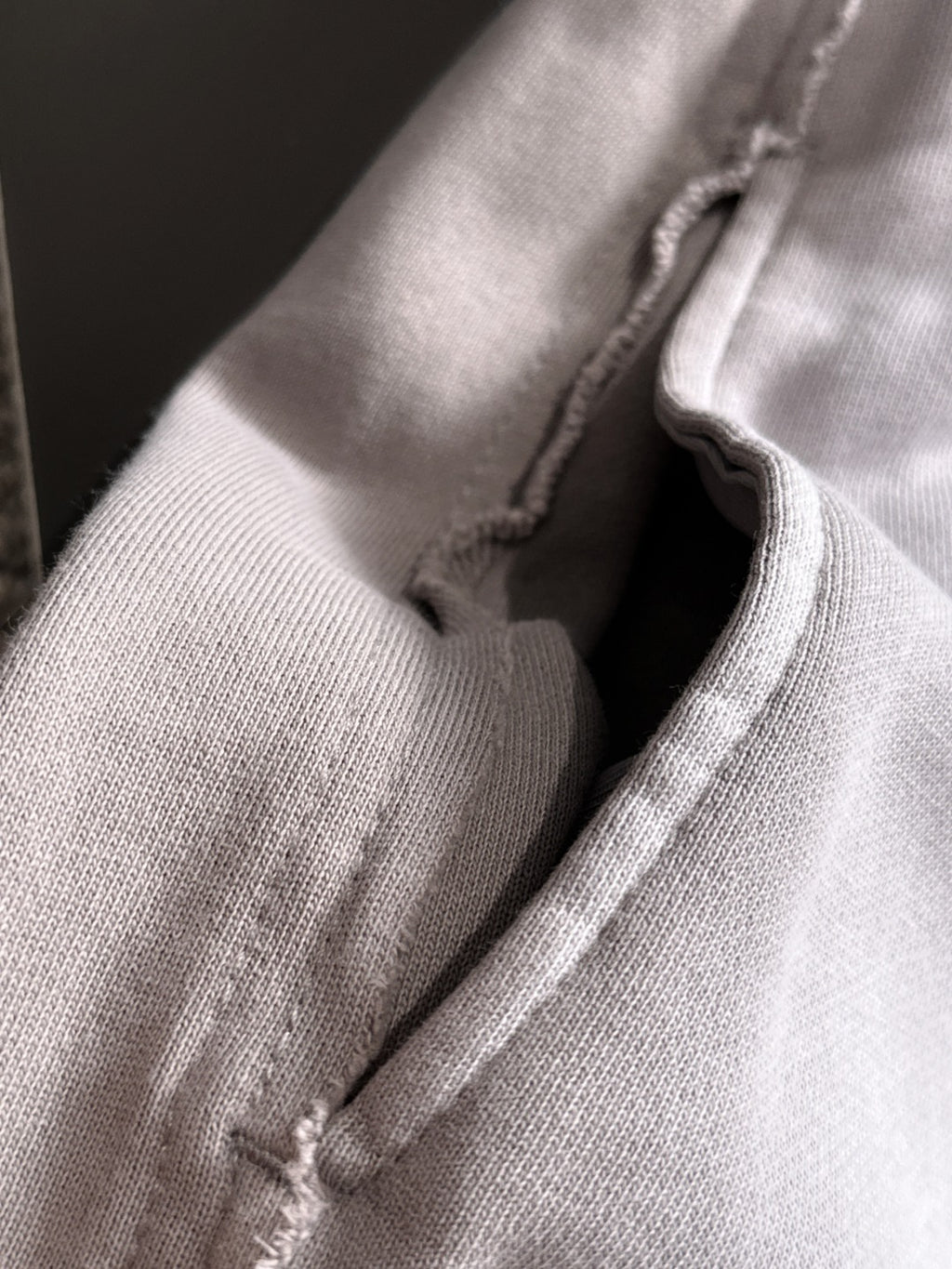 Light gray fabric seam and inner stitching close-up