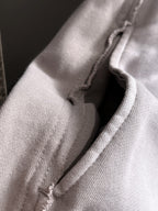 Light gray fabric seam and inner stitching close-up