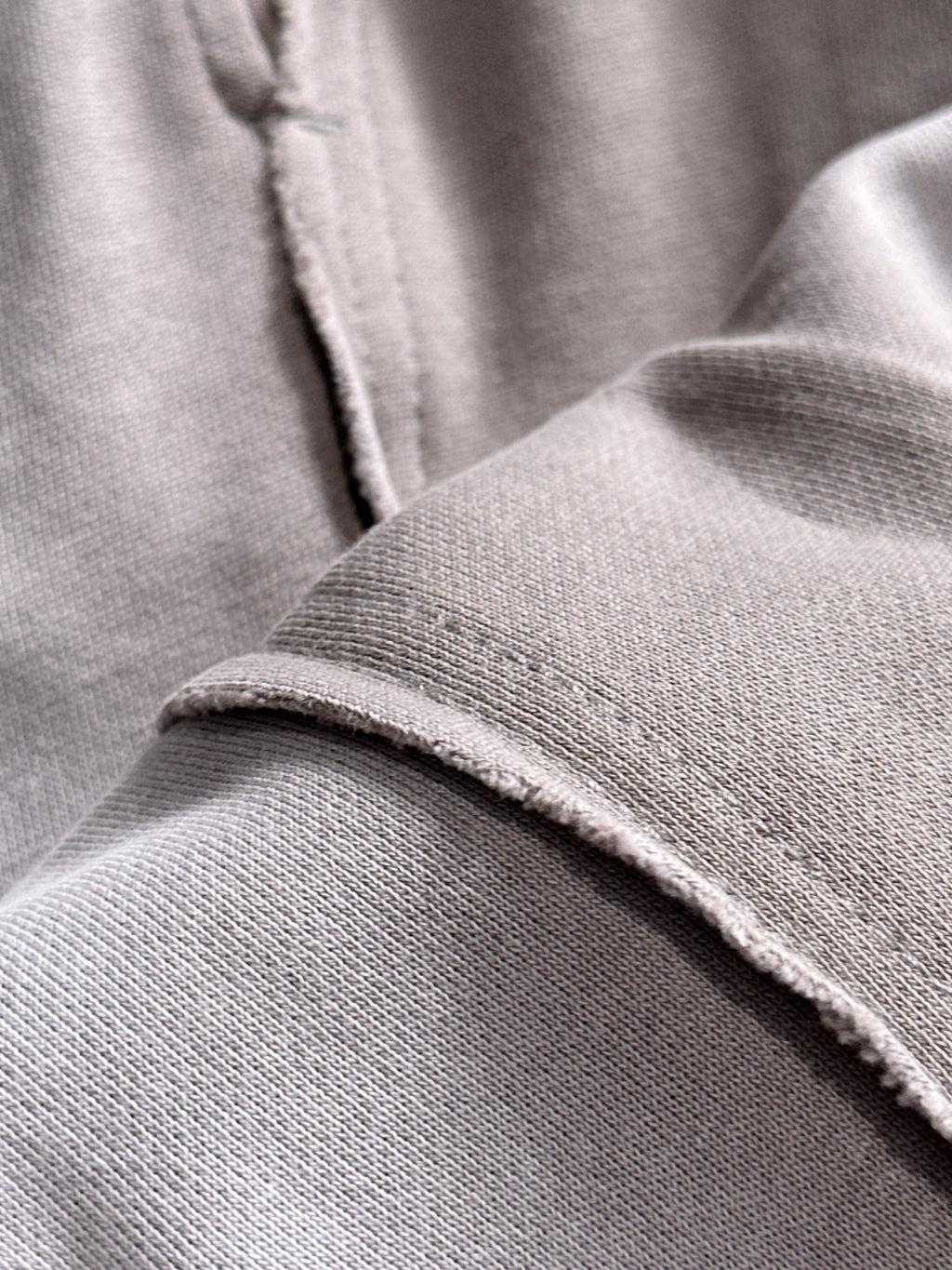 Light gray cotton fabric hem close-up
