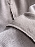 Light gray cotton fabric hem close-up