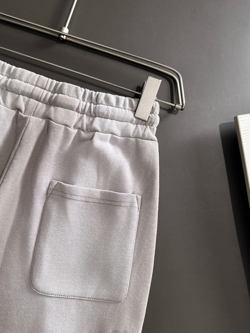 Light gray pants with front pocket and elastic waistband