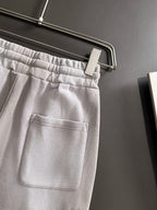 Light gray pants with front pocket and elastic waistband