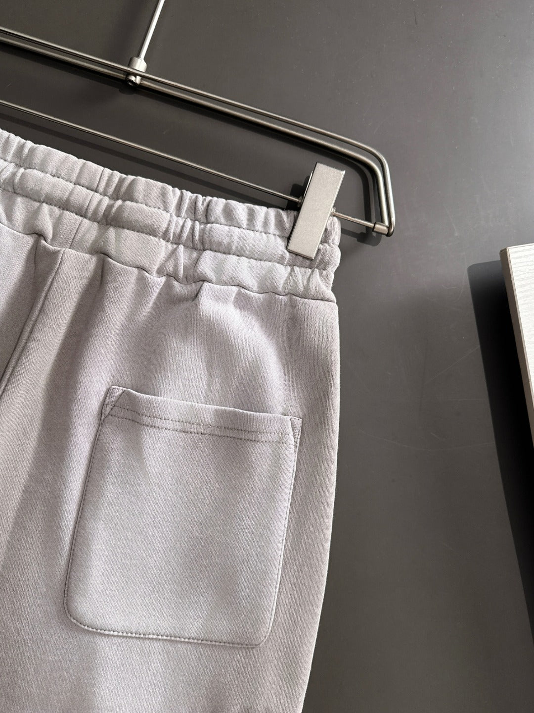 Light gray pants with front pocket and elastic waistband
