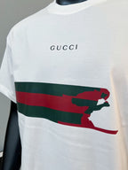 White Gucci T-shirt front with “GUCCI” logo and red/green animal stripe graphic