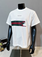 White Gucci T-shirt with “GUCCI” print and red/green striped animal graphic front