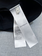 Givenchy T-shirt size and care label tag on black fabric