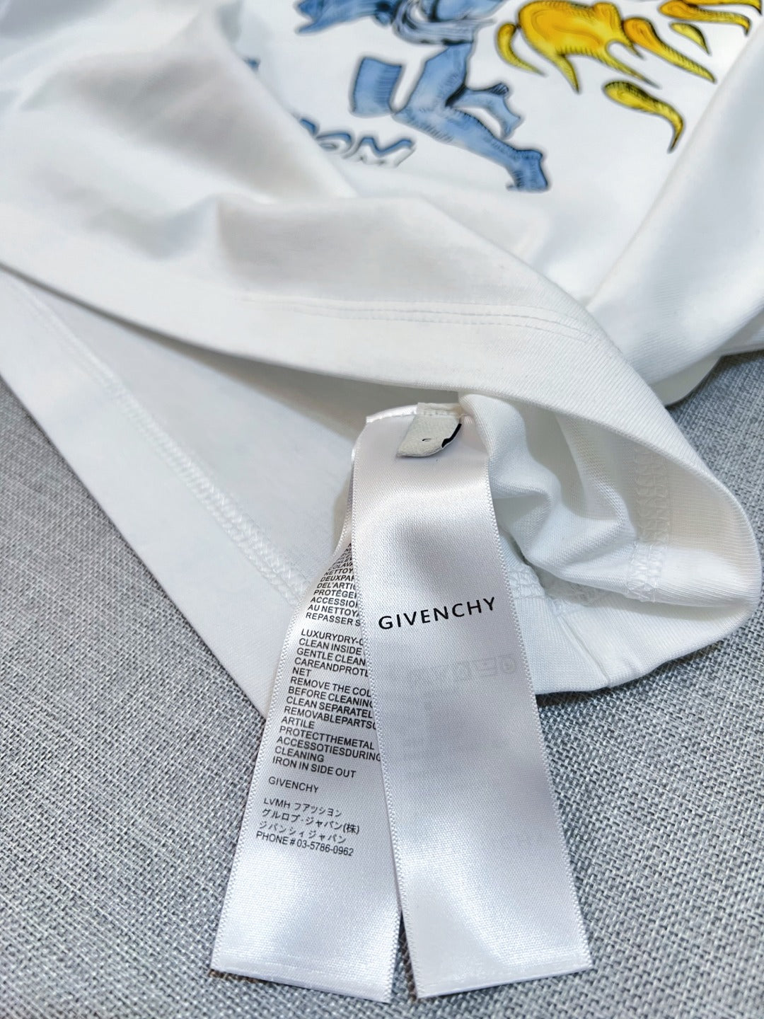 White Givenchy T-shirt with attached care label on the neckline