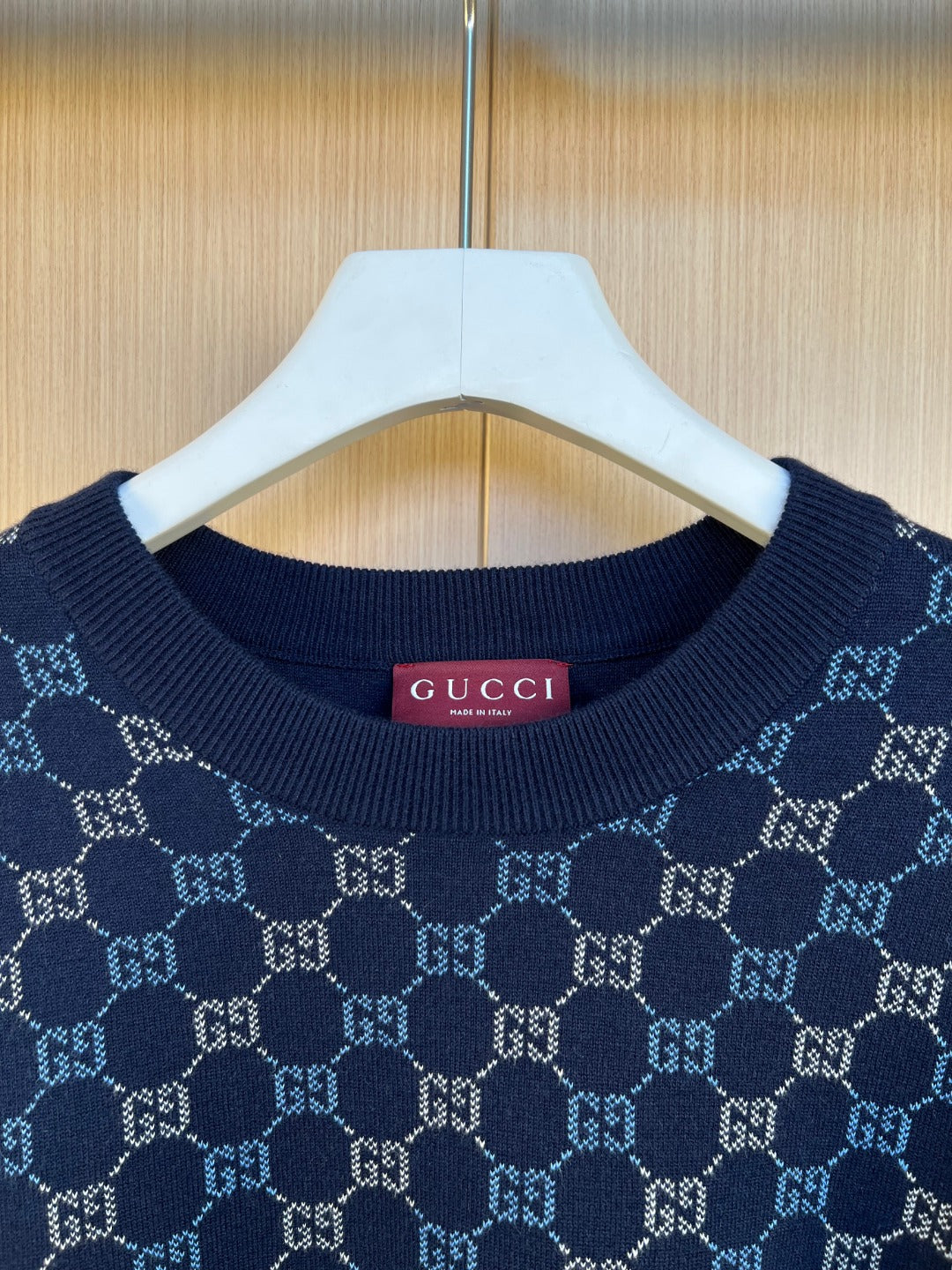 Dark blue Gucci knit sweater neckline with GG monogram pattern and ribbed collar