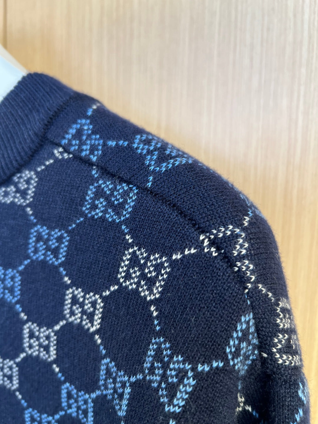 Dark blue knit sweater shoulder with GG monogram pattern