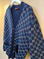 Gucci knit cardigan angled view with navy GG monogram pattern, button-front