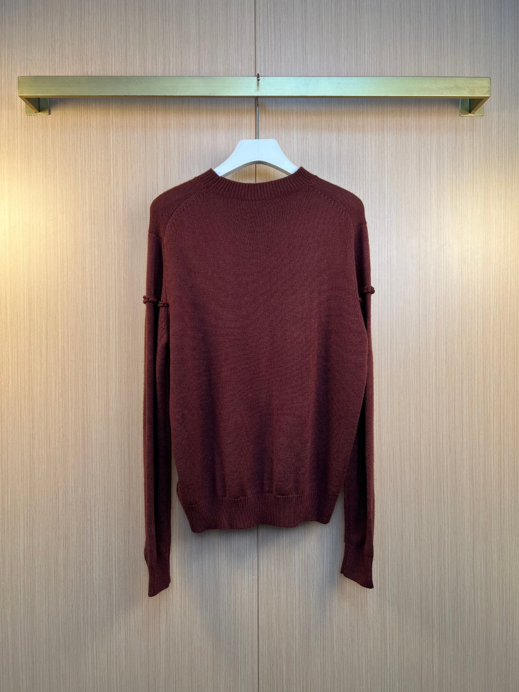 Burgundy knit long-sleeve sweater, back view with ribbed hem