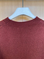 Burgundy knit sweater crewneck close-up with textured ribbed collar