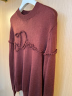 Burgundy knit sweater with heart-shaped embroidered motif and long sleeves