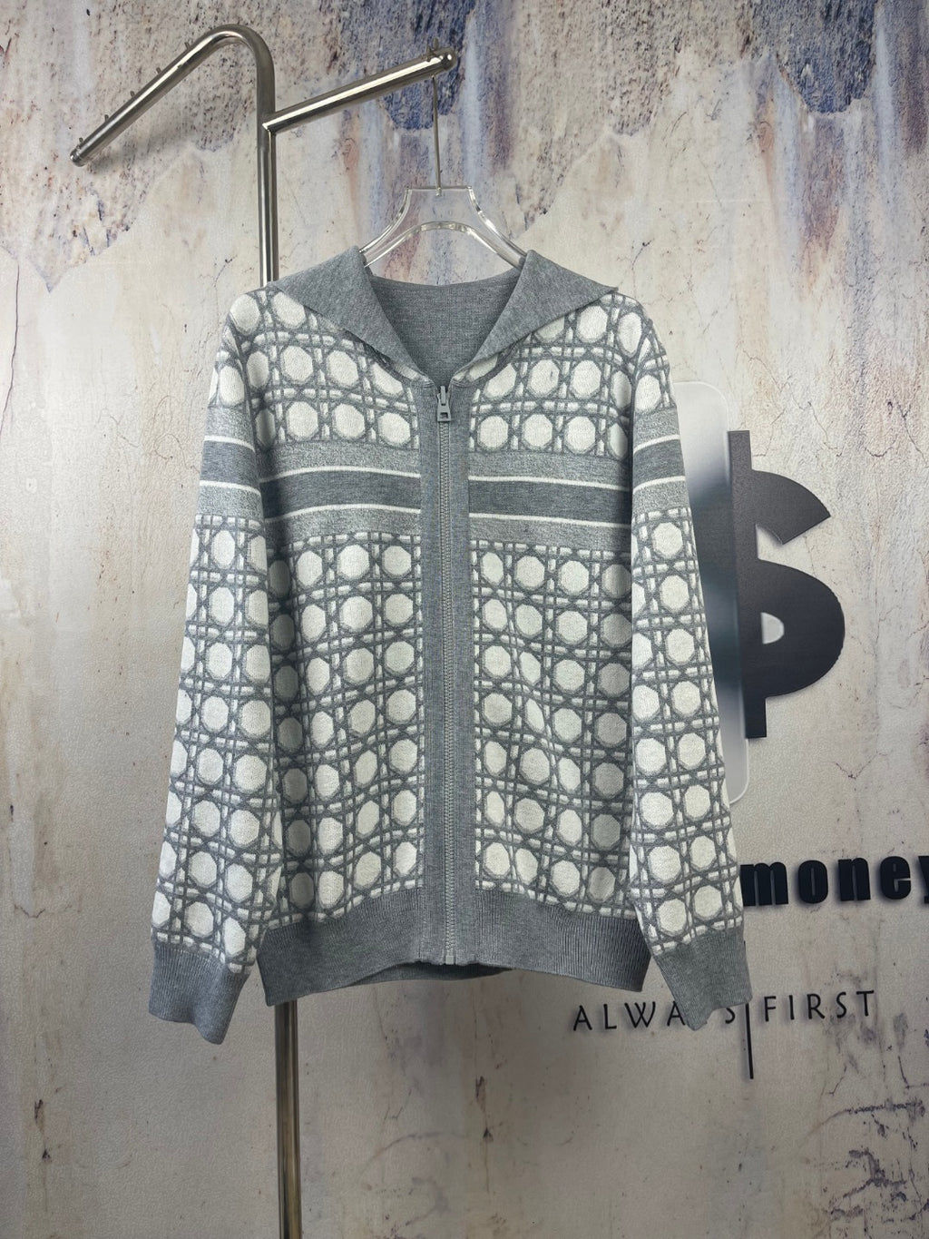 Gray zip-up hoodie with geometric pattern and striped sleeves