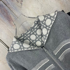Gray zip hoodie front detail with geometric lattice print and hood