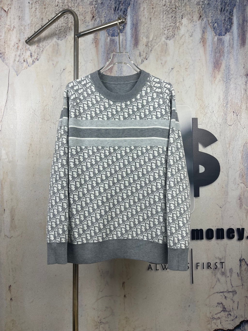 Long-sleeve crewneck sweater in dark and light gray knit, patterned front, ribbed cuffs