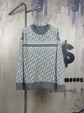 Long-sleeve crewneck sweater in dark and light gray knit, patterned front, ribbed cuffs