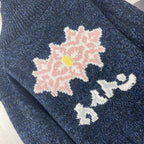 Louis Vuitton navy knit jacket close-up with pink floral and white motif intarsia