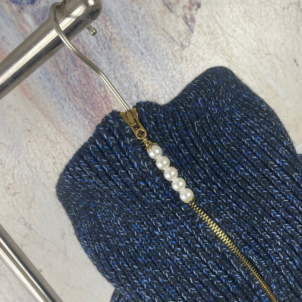 Louis Vuitton navy knit zip jacket close-up with faux pearl and gold zipper pull