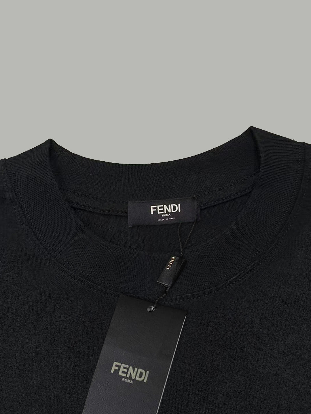 Black Fendi T-shirt neckline with attached brand tag at collar