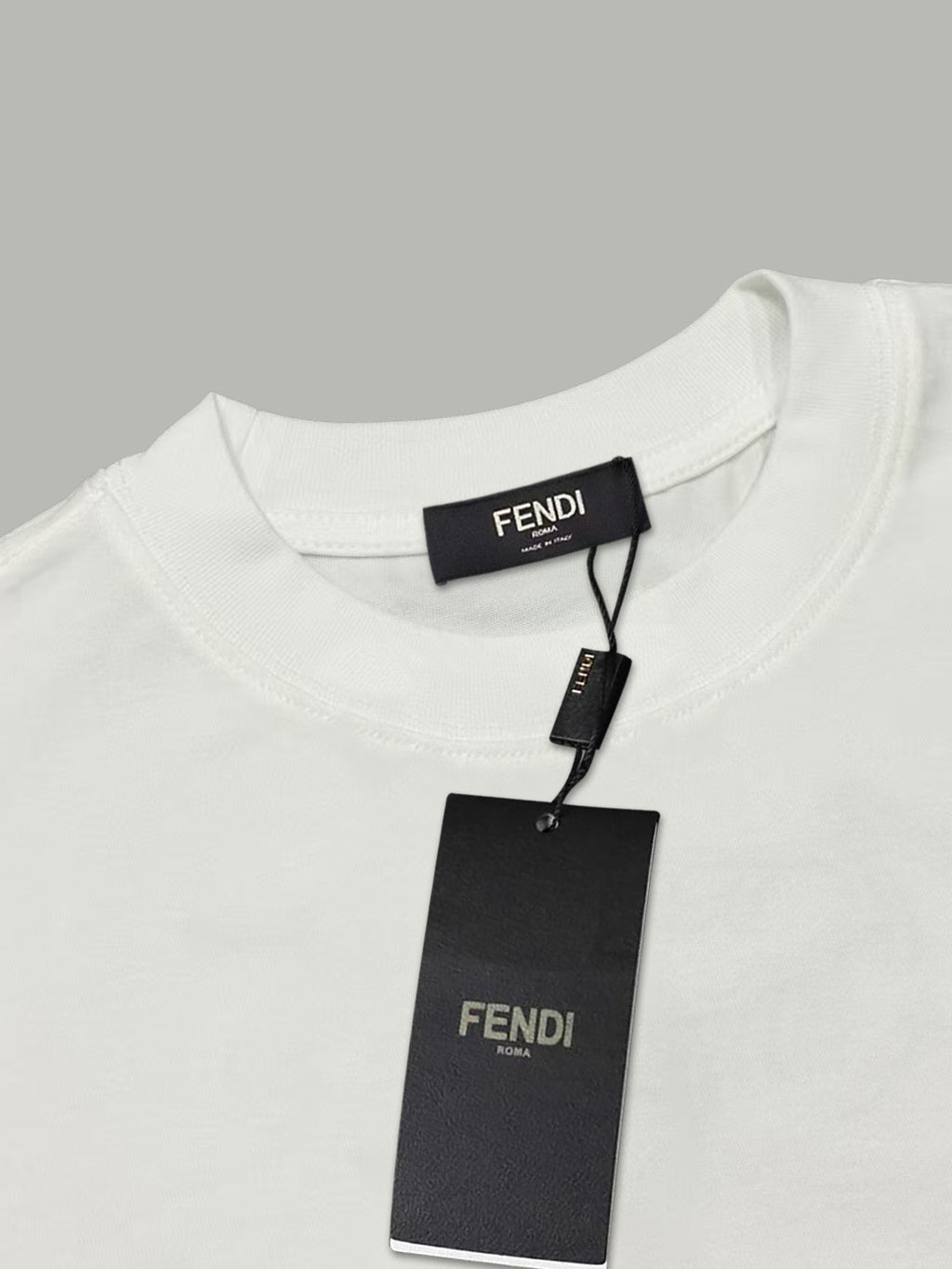 White Fendi T-shirt with black hang tag and 'FENDI' label