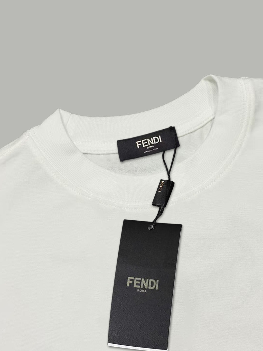 White Fendi T-shirt with black hang tag and 'FENDI' label