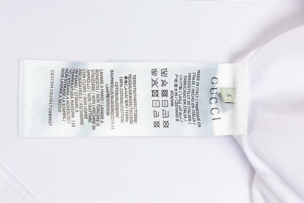 White Gucci T-shirt interior care label with size markings near collar