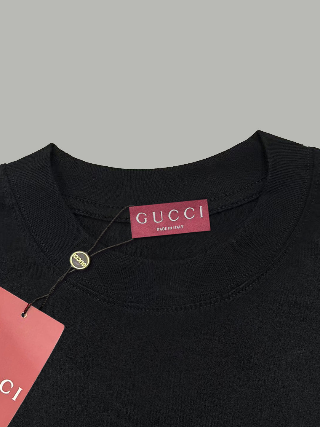 Black Gucci T-shirt neckline with Gucci label and small round button
