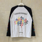 Raglan long-sleeve T-shirt in white and black with colorful floral logo back print.