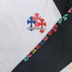 Raglan sleeve logo print with red and blue flower motifs on white and black fabric.