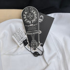 White and black raglan T-shirt with attached hang tags and barcode label.