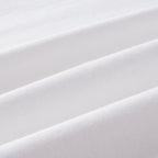 White knit T-shirt fabric texture, close-up with soft folds.