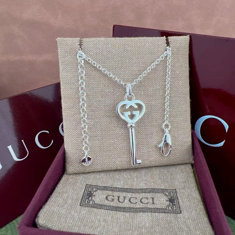 Gucci key pendant necklace with heart and G charm, silver-tone chain